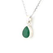 Necklace with a green teardrop pendant on a white background