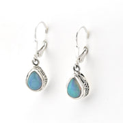 Pair of silver earrings with blue teardrop stones on a white background