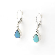 Teardrop-shaped earrings with blue gemstones on a white background