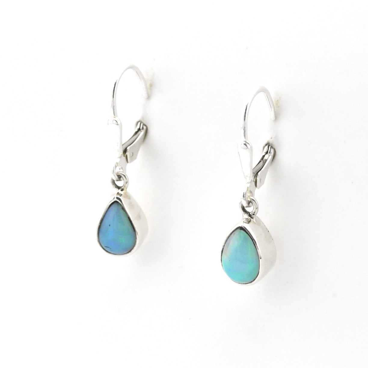 Teardrop-shaped earrings with blue gemstones on a white background