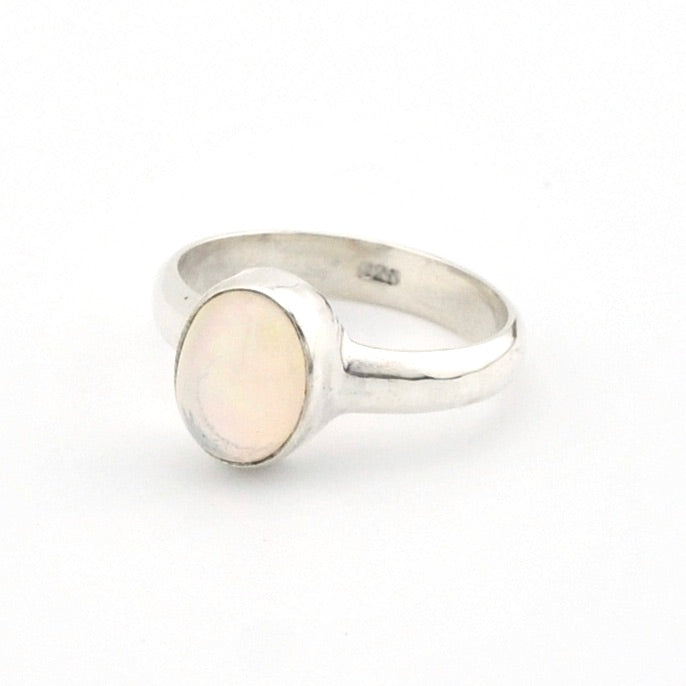 Silver ring with a opal stone on a white background