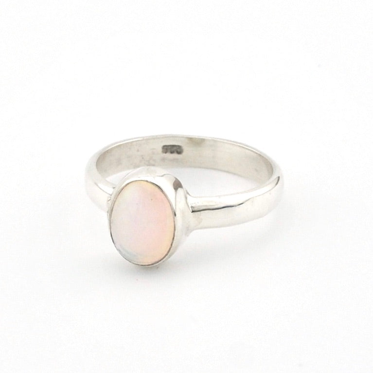 Silver ring with a pink stone on a white background