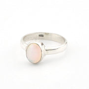 Silver ring with a pink stone on a white background