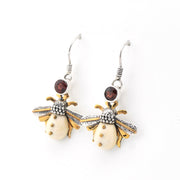 Bee-shaped earrings with gold and silver details on a white background