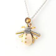 Jewelry necklace with a bee-shaped pendant on a white background