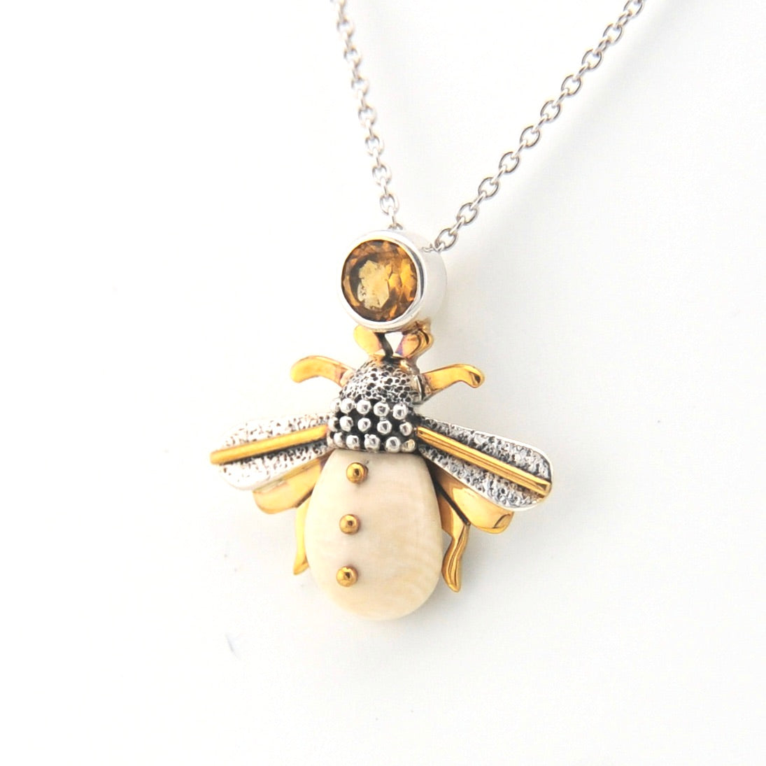 Jewelry necklace with a bee-shaped pendant on a white background