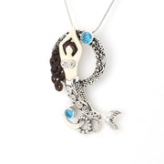 Mermaid pendant necklace with blue accents on a white background