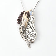 Mermaid pendant necklace on a white background