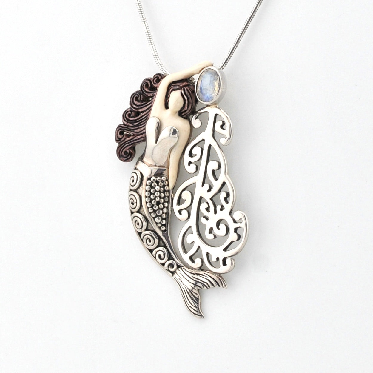 Mermaid pendant necklace on a white background