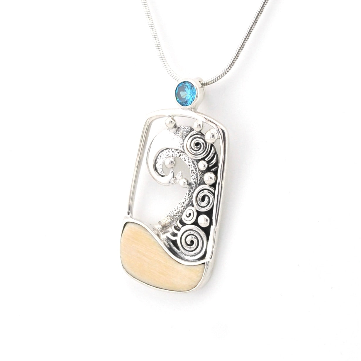 Silver wave pendant with a blue gemstone on a white background