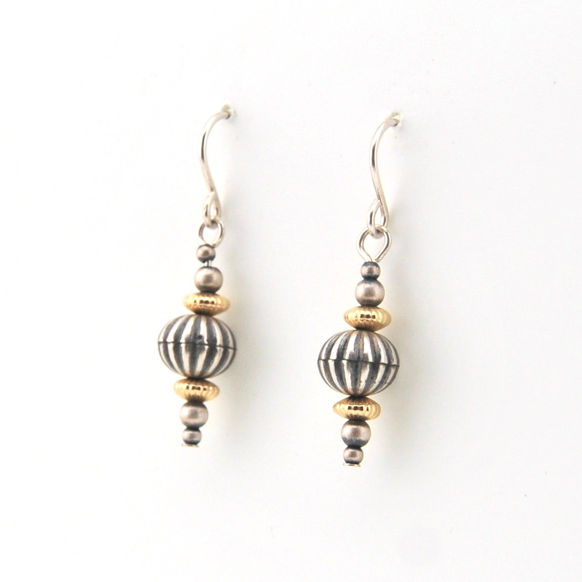 Pair of earrings with striped beads on a white background