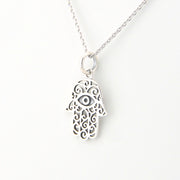 Silver Hamsa hand necklace on a white background