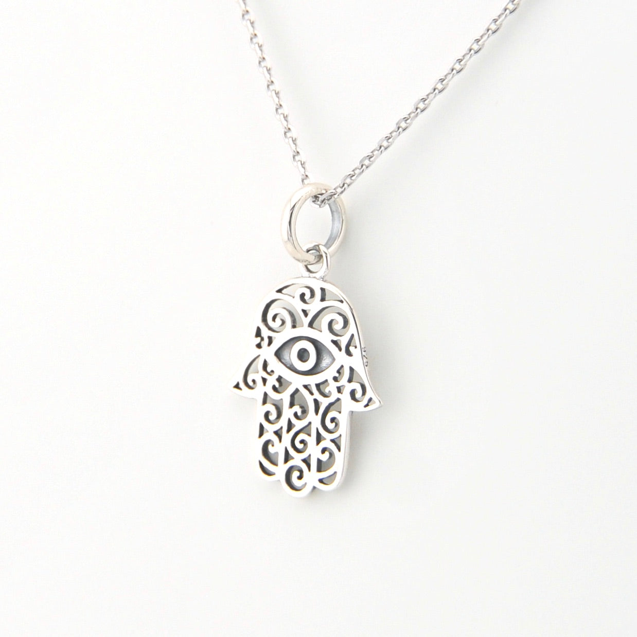 Silver Hamsa hand necklace on a white background