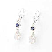 Pair of silver earrings with teardrop-shaped stones on a white background