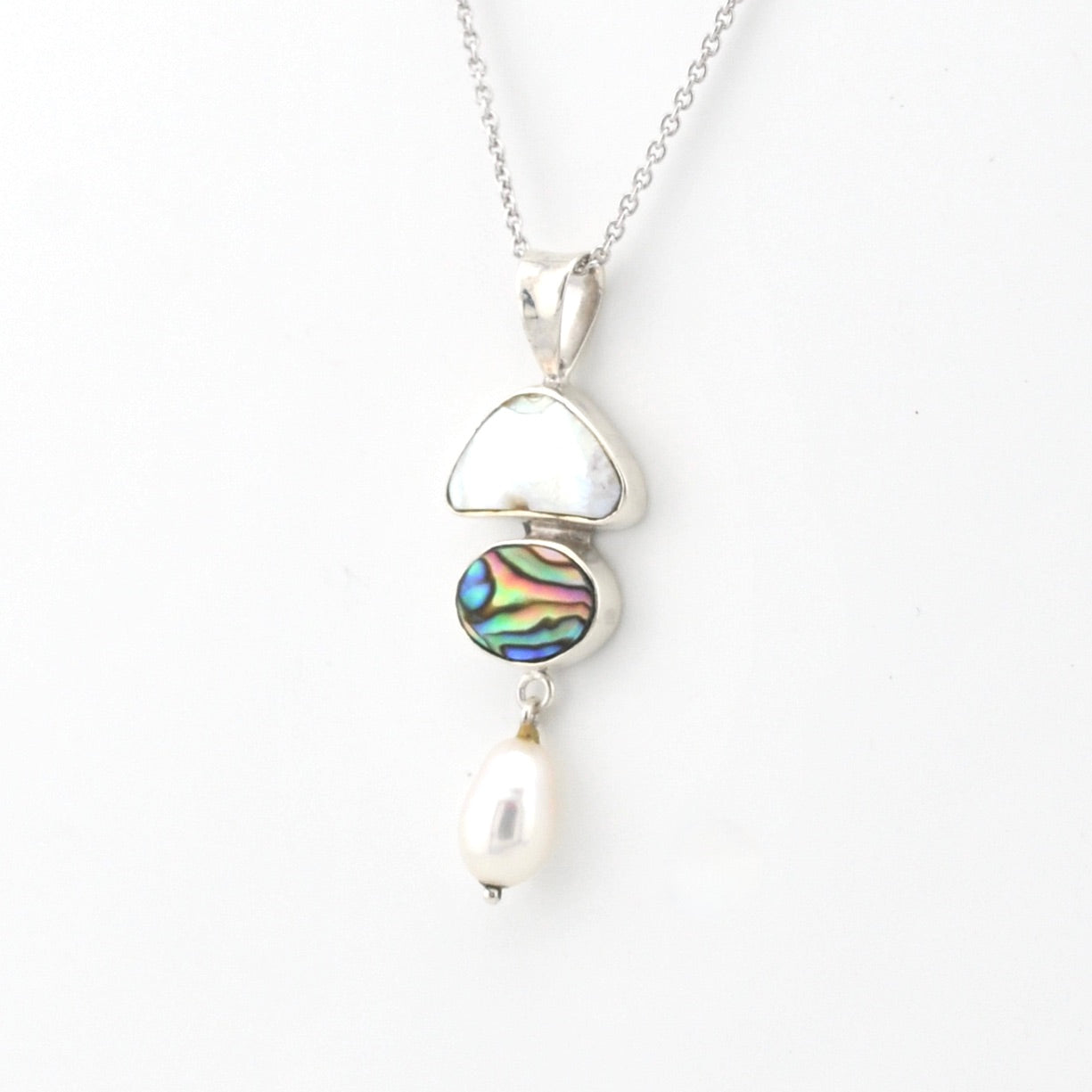 Necklace with a pendant featuring a colorful gemstone and pearl on a white background