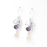 Pair of earrings with gemstones and pearls on a white background