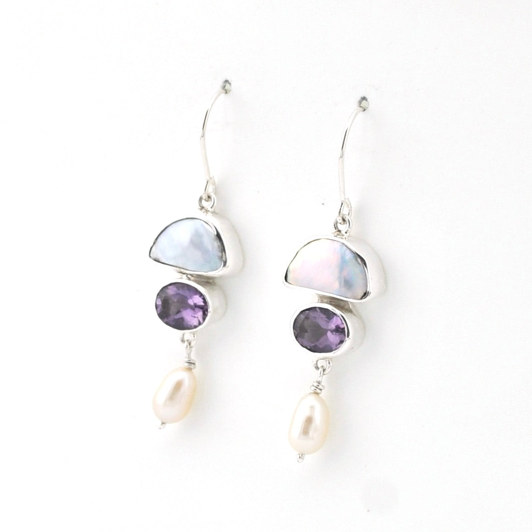 Pair of earrings with gemstones and pearls on a white background