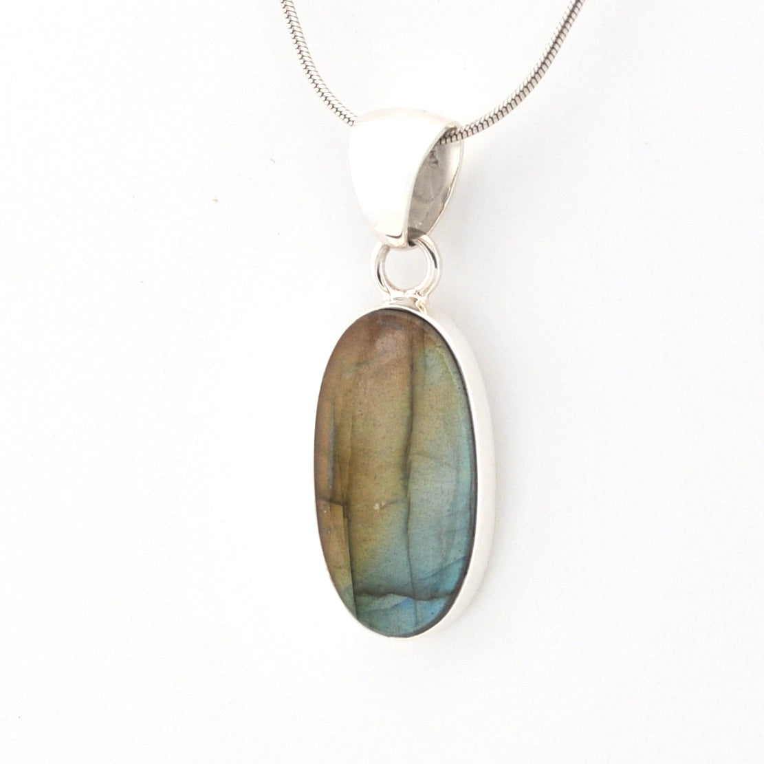 Labradorite pendant on a silver chain against a white background