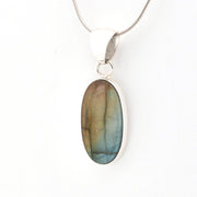 Labradorite pendant on a silver chain against a white background