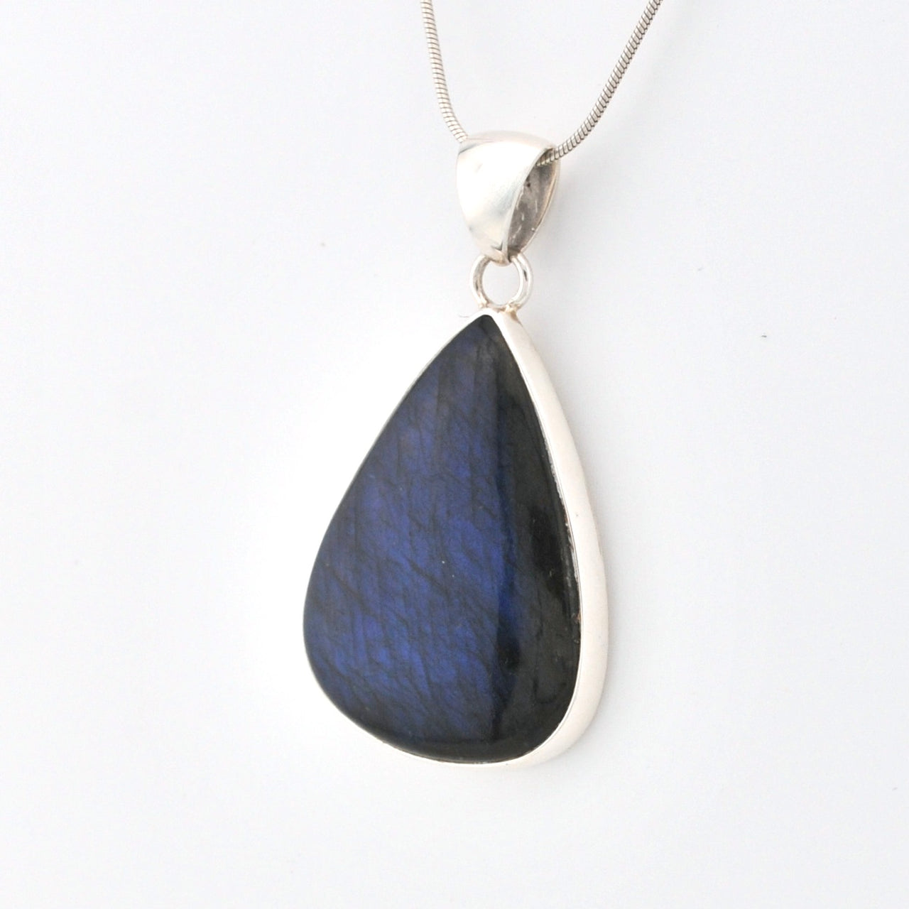 Teardrop-shaped blue pendant on a white background