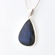 Teardrop-shaped blue pendant on a white background
