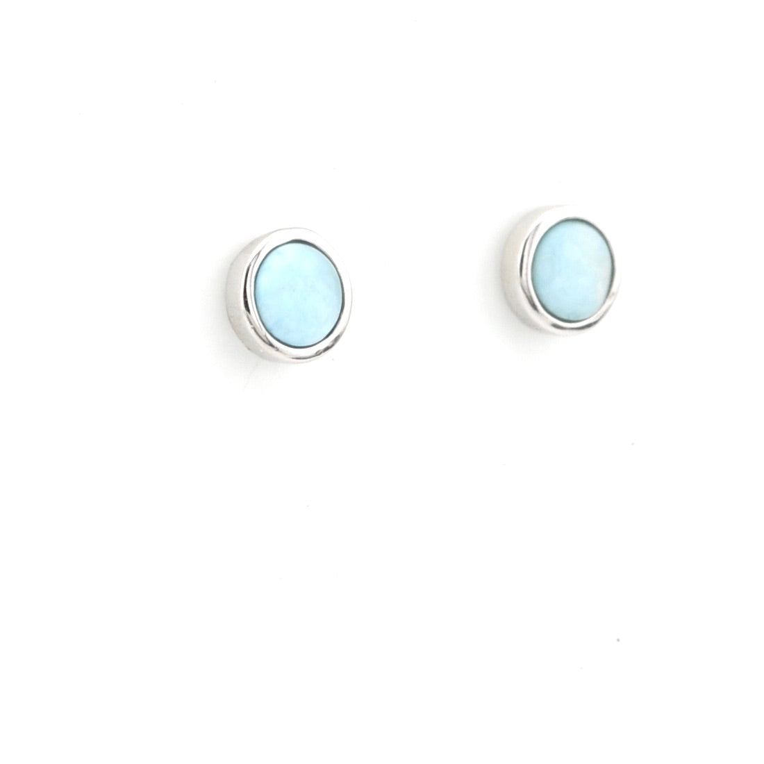 Pair of round earrings with light blue gemstones on a white background