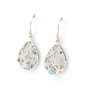 Silver teardrop earrings with starfish designs on a white background