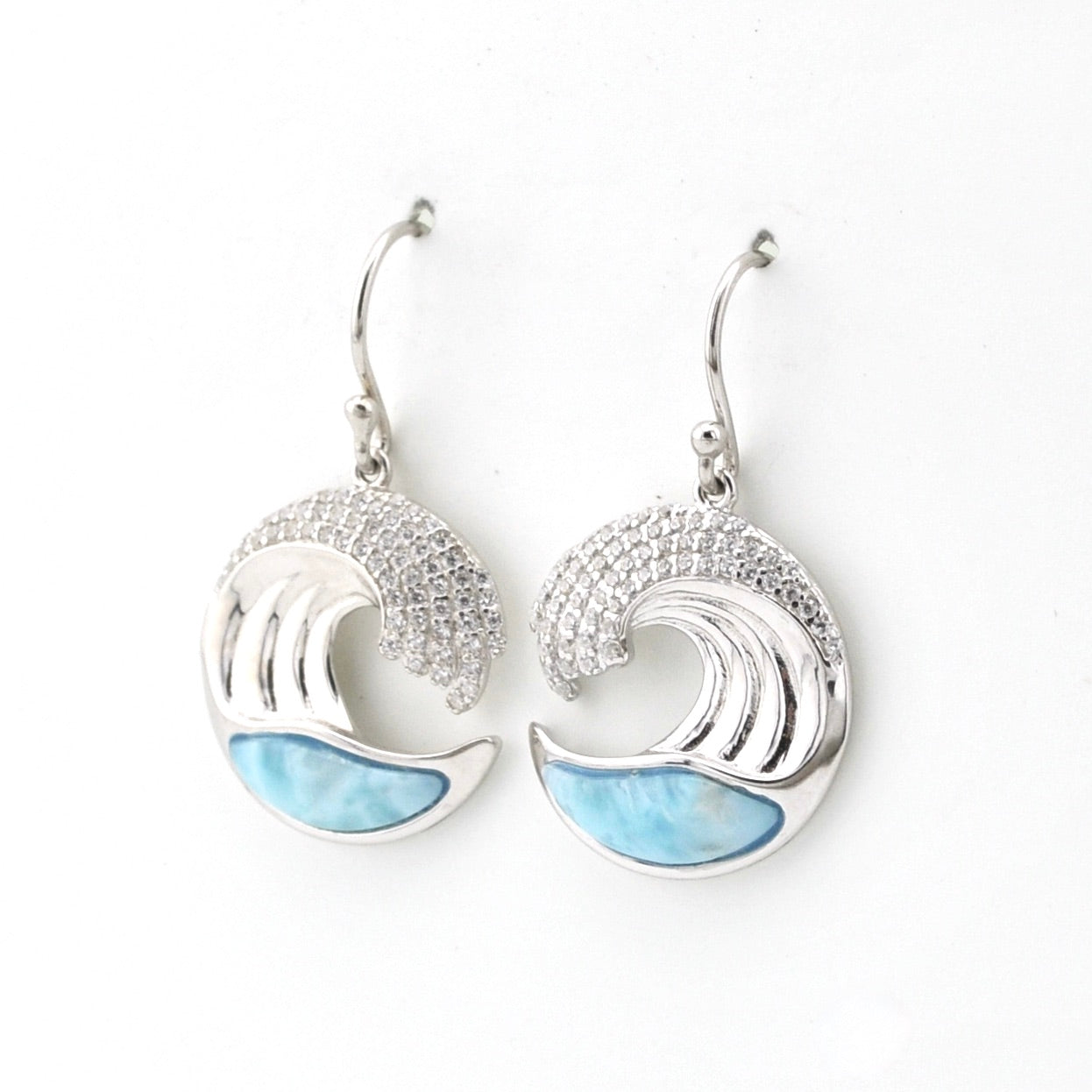 Silver earrings with wave design and blue accents on a white background