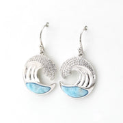 Silver earrings with wave design and blue accents on a white background