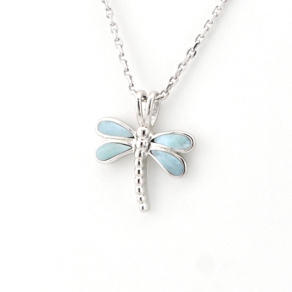 Dragonfly-shaped pendant on a chain against a white background