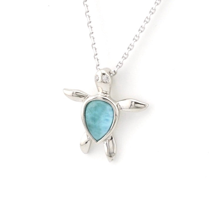 Turtle-shaped pendant with a blue stone on a white background