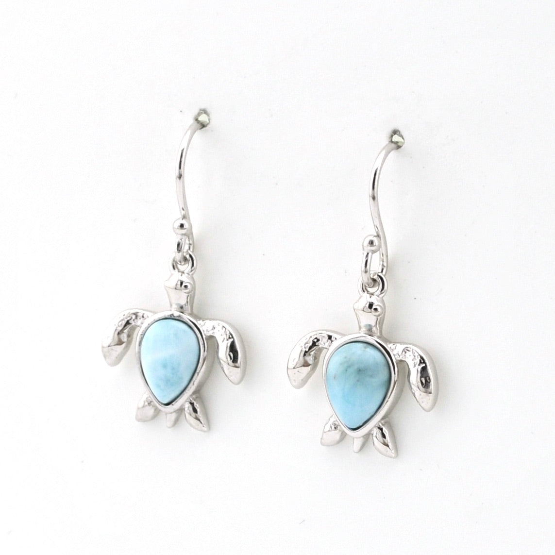 Turtle-shaped earrings with blue gemstones on a white background