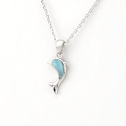 Silver necklace with a dolphin pendant featuring a blue center on a white background