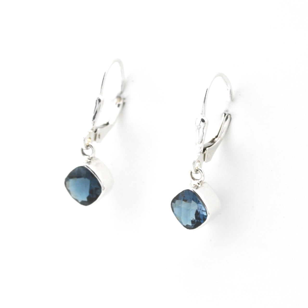 Silver earrings with blue gemstones on a white background