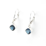 Silver earrings with blue gemstones on a white background