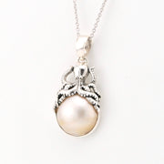 Pearl pendant with octopus necklace on a white background