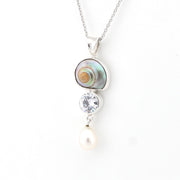 Necklace with shell, crystal, and pearl pendant on a white background