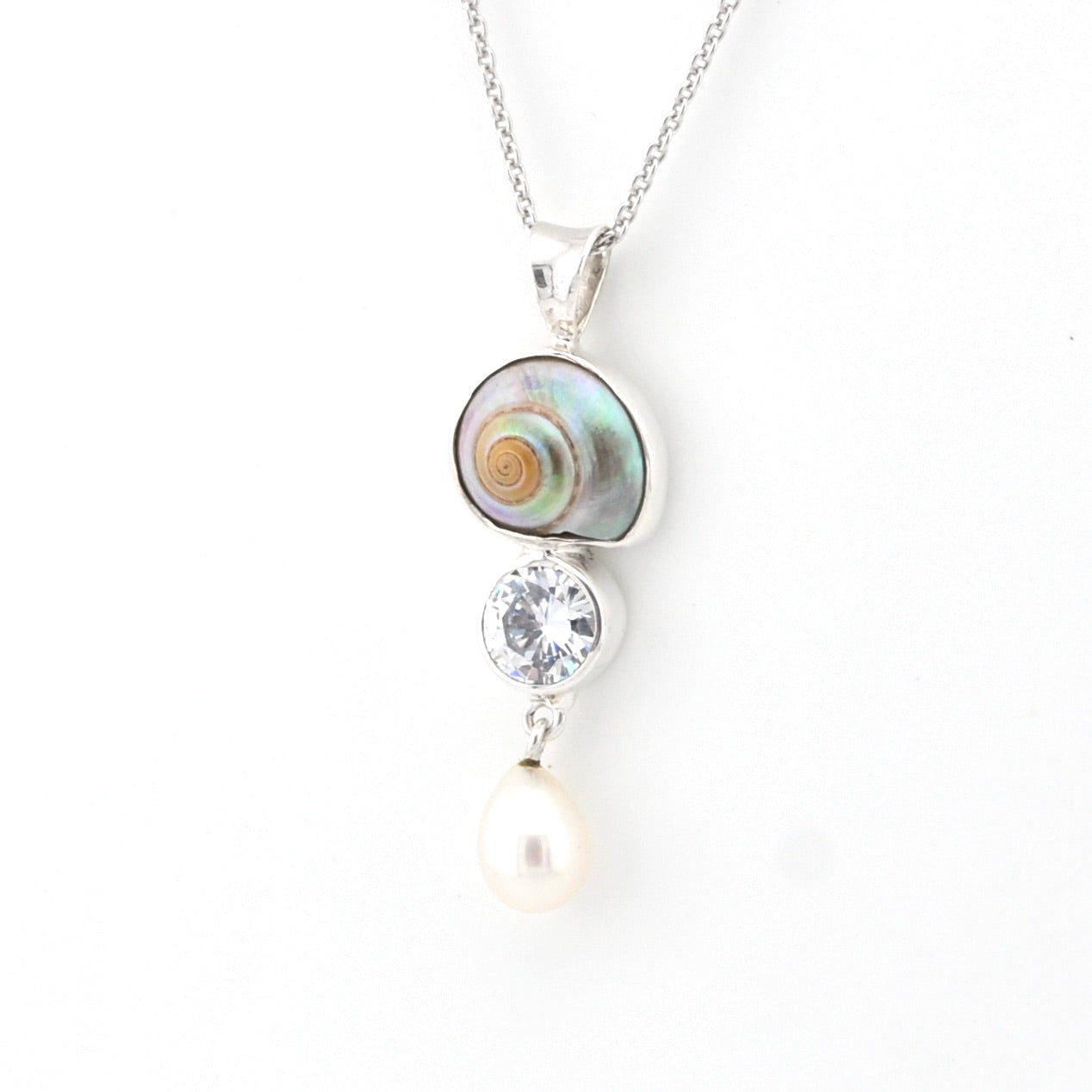 Necklace with shell, crystal, and pearl pendant on a white background