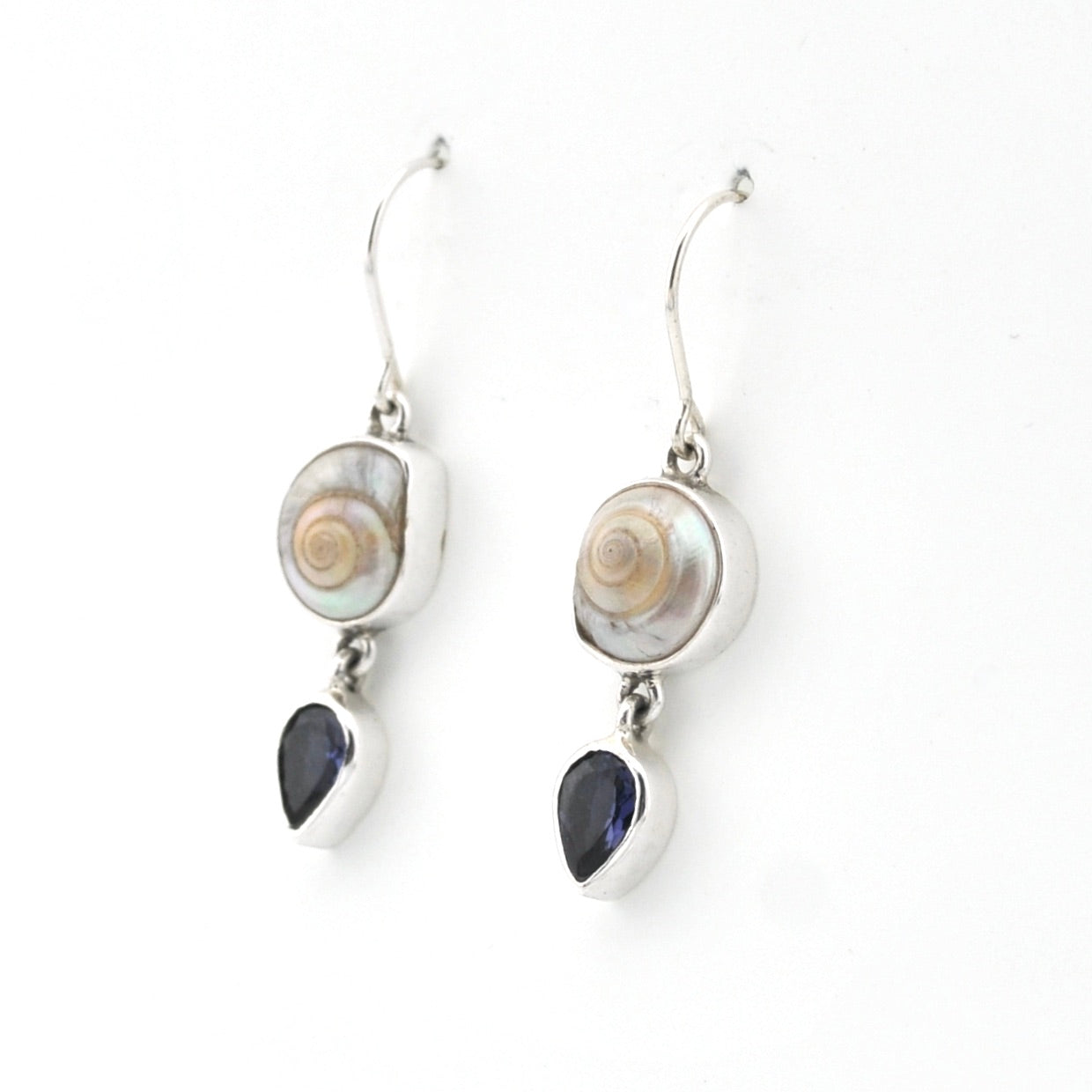 Pair of earrings with shell and teardrop-shaped gemstones on a white background