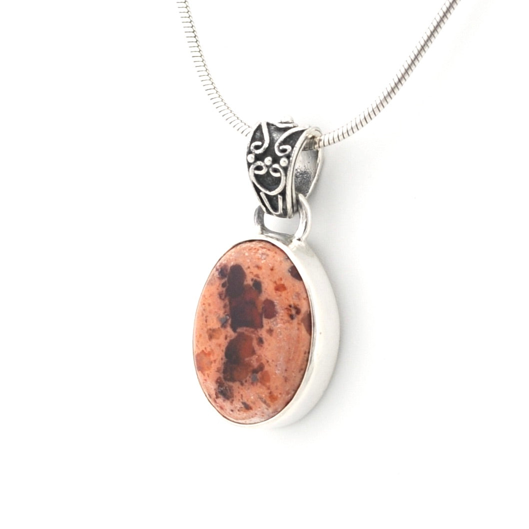Necklace with an oval pendant featuring a natural stone design on a white background