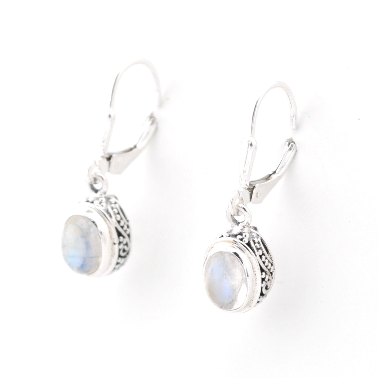 Silver earrings with moonstone stones on a white background
