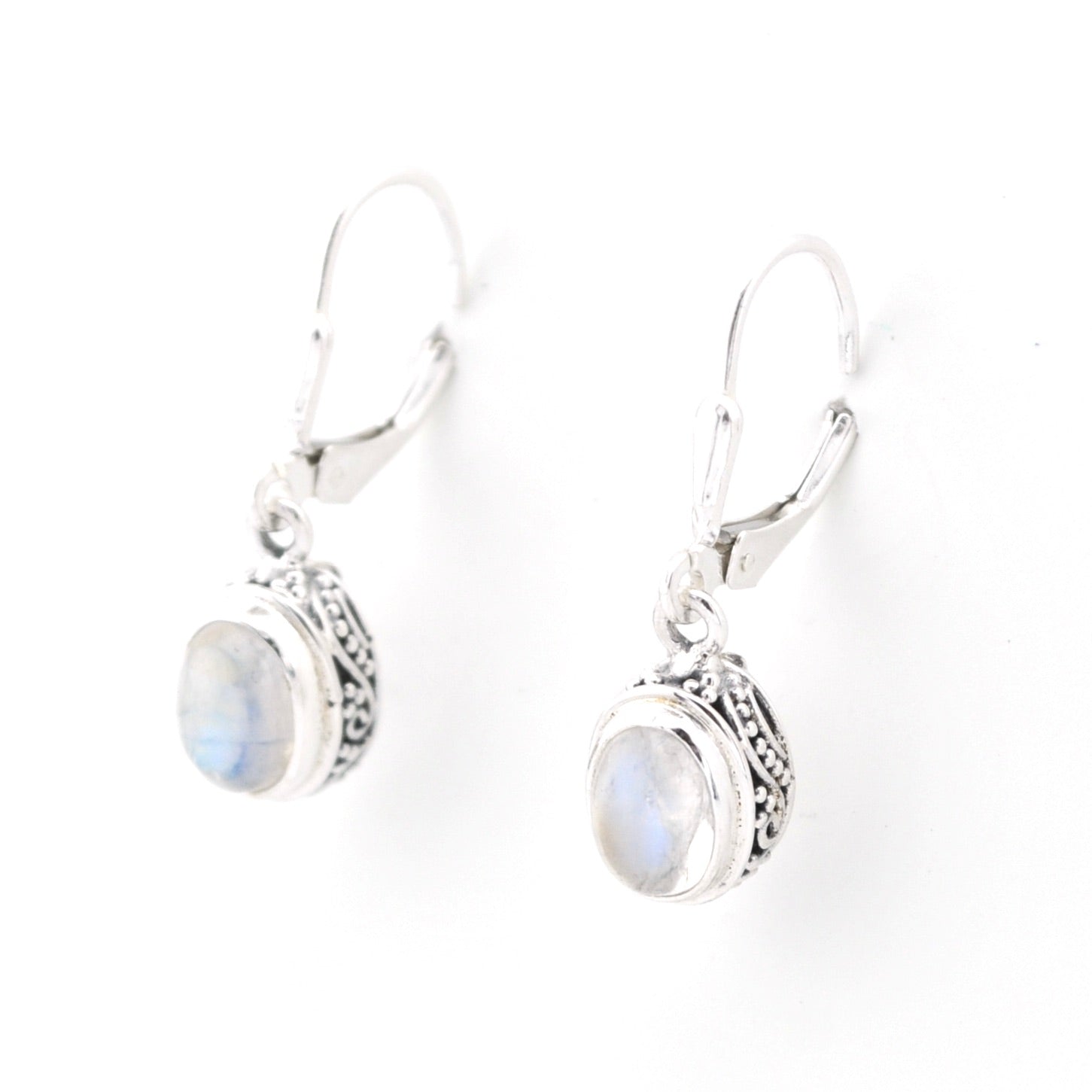 Silver earrings with moonstone stones on a white background