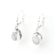 Pair of silver earrings with oval gemstones on a white background