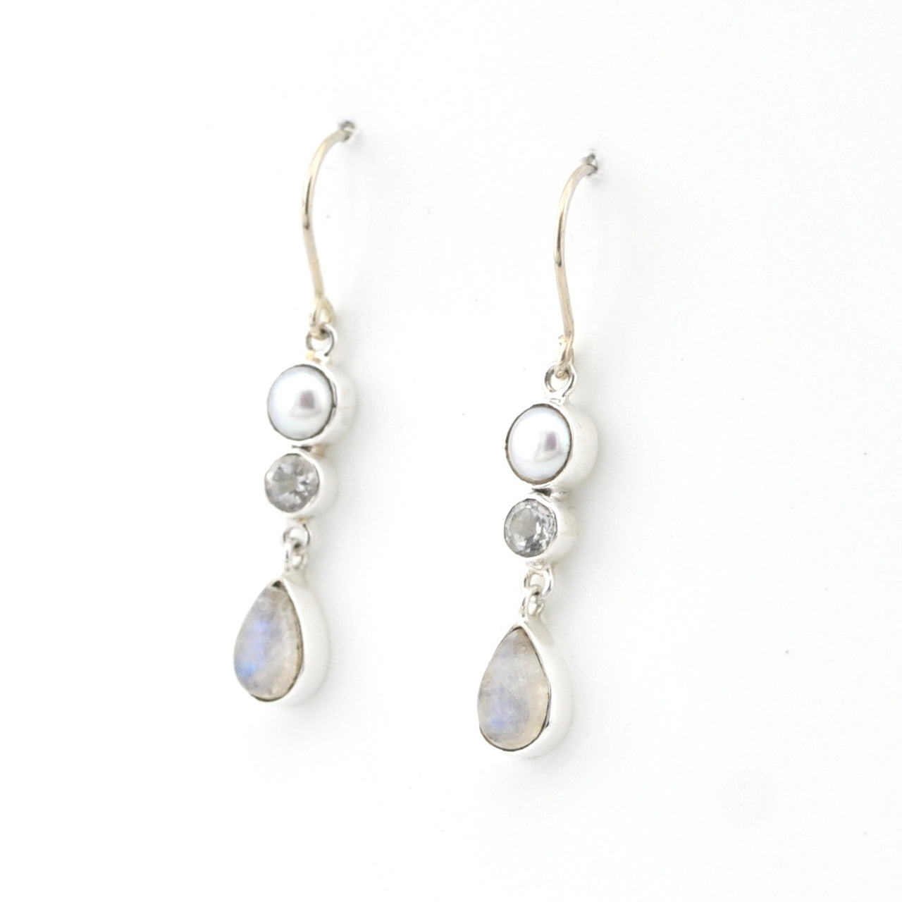 Pair of silver earrings with teardrop-shaped gemstones on a white background