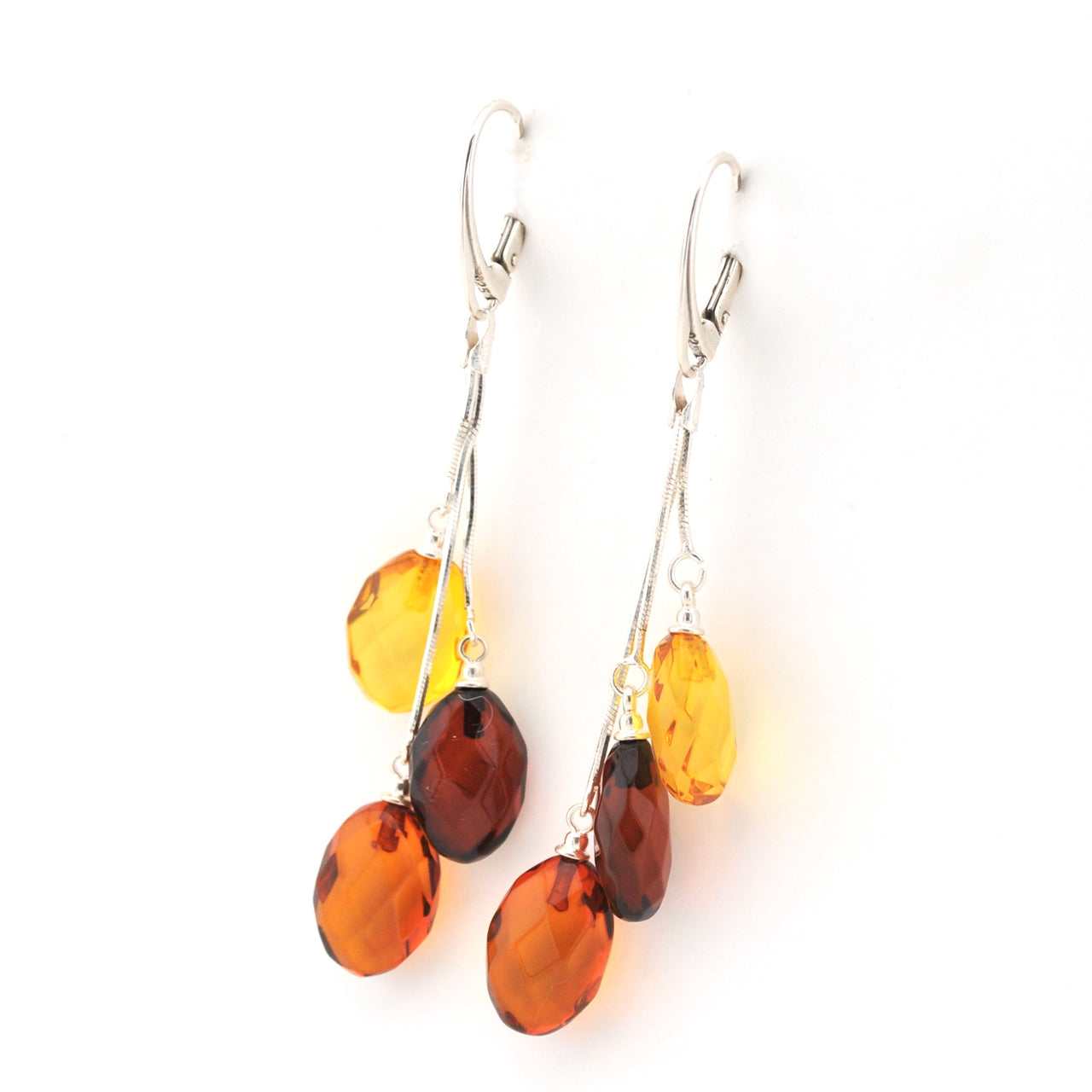 Pair of amber teardrop earrings on a white background
