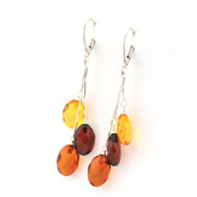 Pair of amber teardrop earrings on a white background