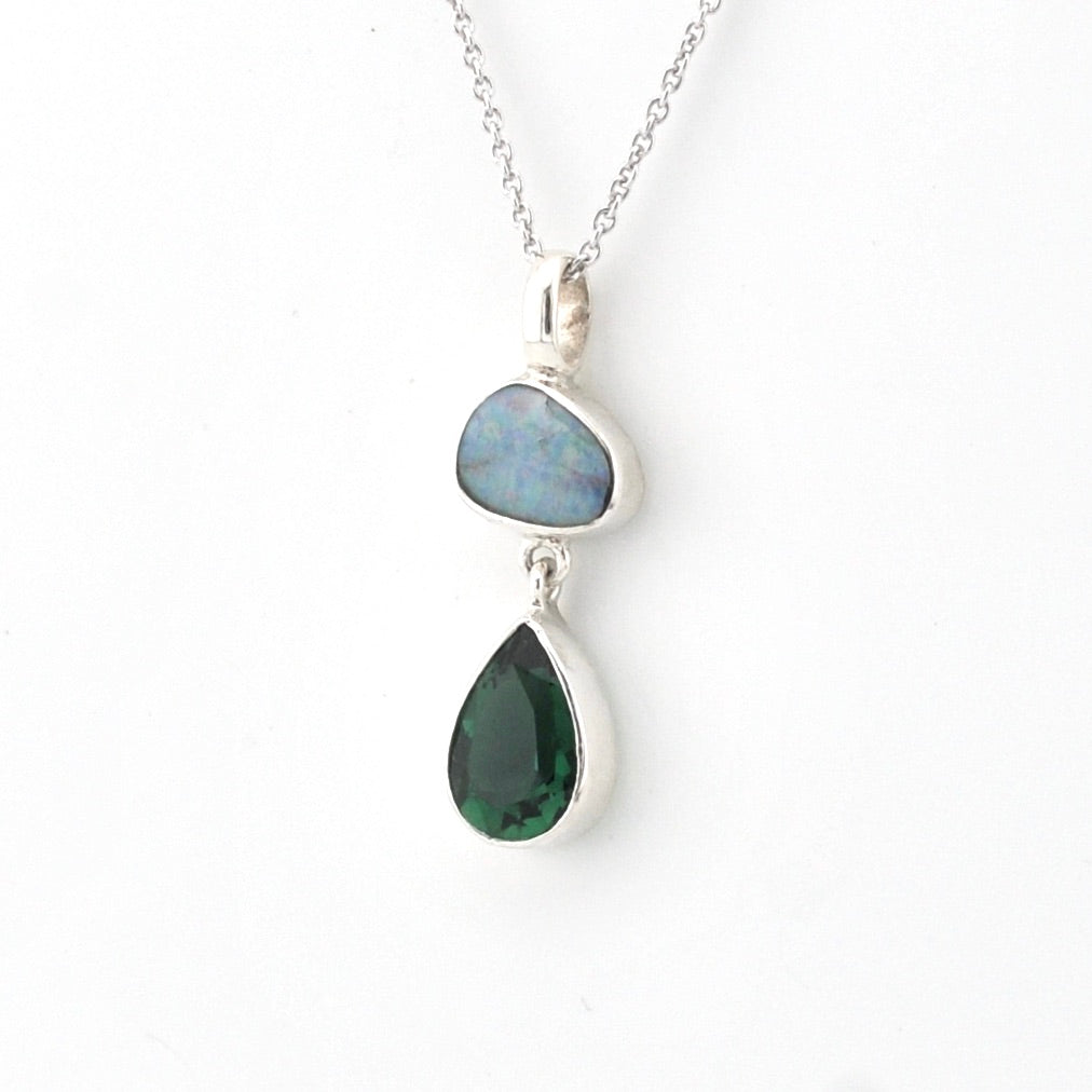 Necklace with two teardrop-shaped gemstones on a white background