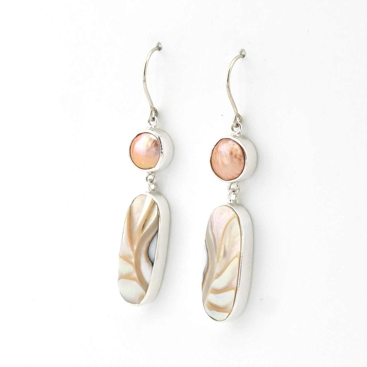 Pair of earrings with shell-like design on a white background