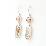 Pair of earrings with shell-like design on a white background