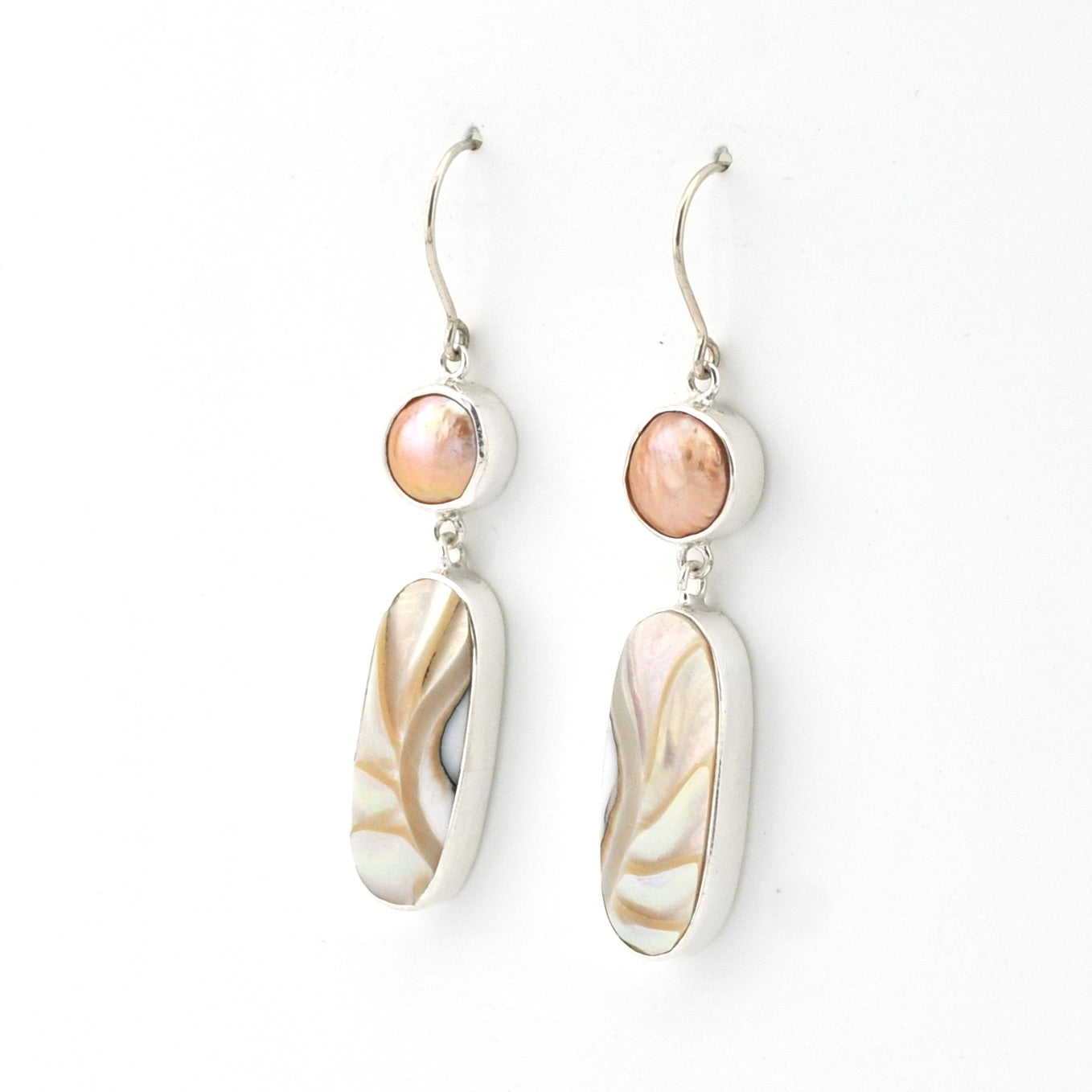 Pair of earrings with shell-like design on a white background
